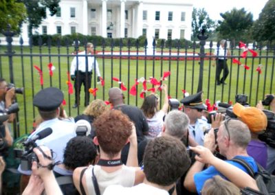 AIDS Activists Tie Red Ribbons with Donations to AIDS to White House Fence Calling on Obama to Support Robin Hood Tax